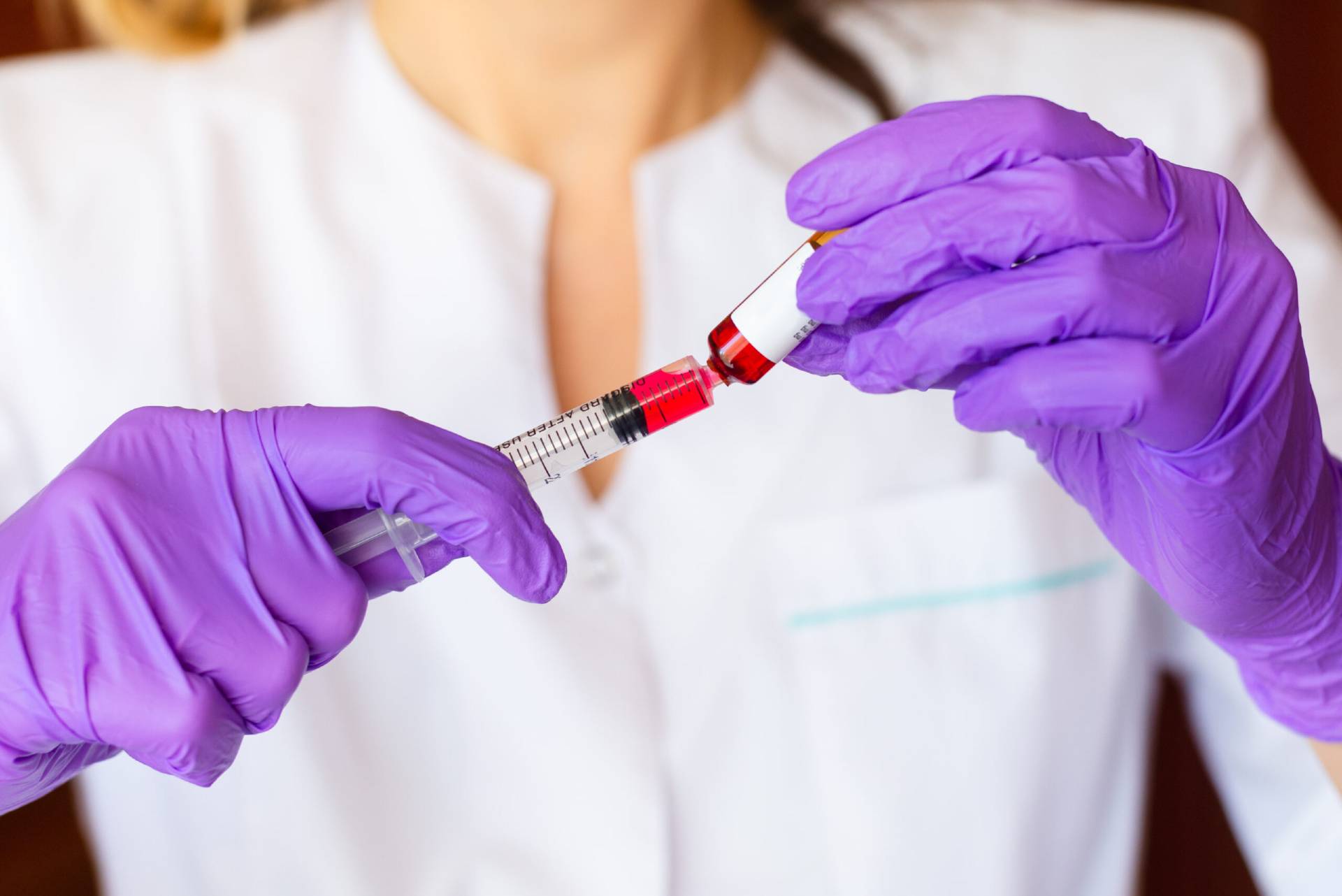 Woman hands holding syringe for LipoShots and B12 Shots Atomic Dermatology and Med Spa