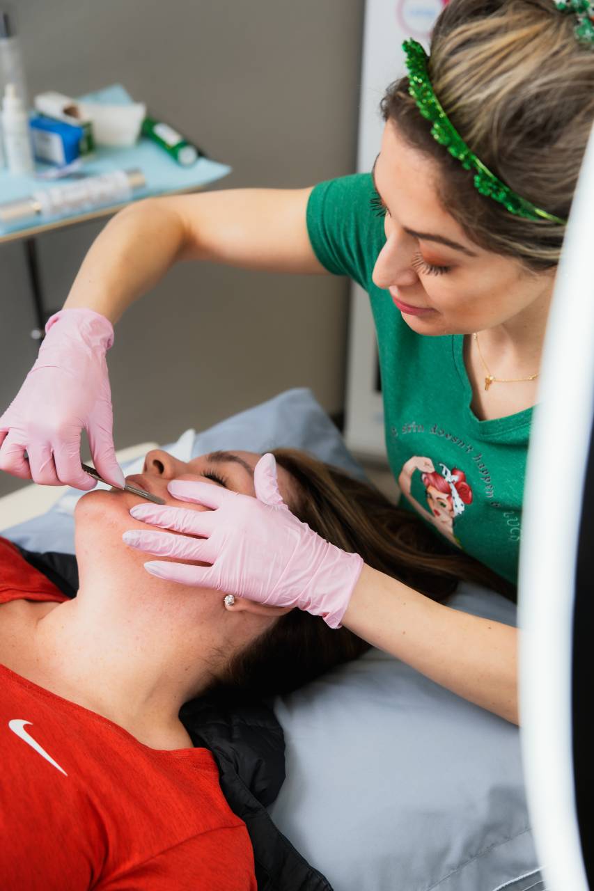 a facial procedure being performed by Atomic Dermatology and Med Spa